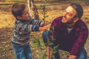 father and son planting tree